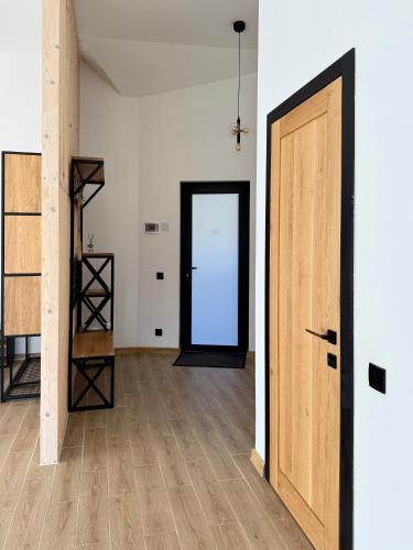 an empty room with a door and a wooden floor at Шишка in Bukovel