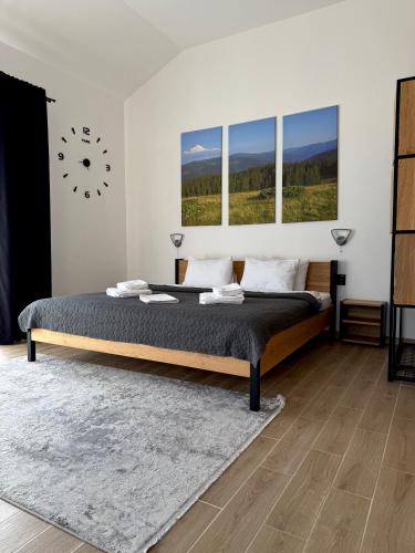 a bedroom with a large bed with two windows at Шишка in Bukovel
