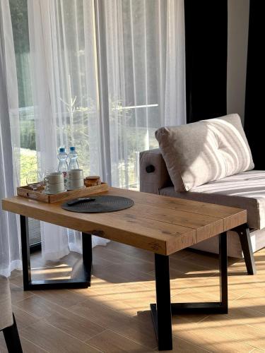 a wooden coffee table in front of a window at Шишка in Bukovel