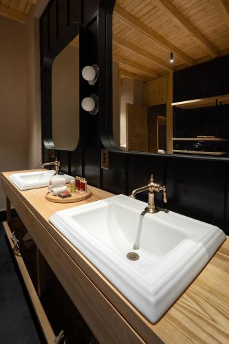 a bathroom with a sink and a mirror at The Postcard in The Himalayan Willows, Stok, Leh in Leh