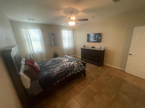 a bedroom with a bed and a flat screen tv at Casa Bonita in Horizon City