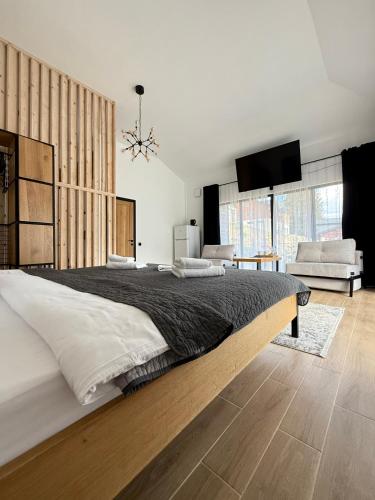 a bedroom with a large bed and a tv at Шишка in Bukovel