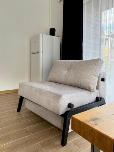 a couch sitting in a room with a refrigerator at Шишка in Bukovel