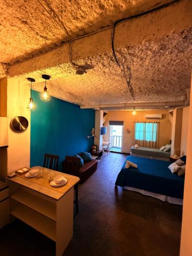a room with a bed and a table in it at Sunset View - Mini Loft in La Libertad