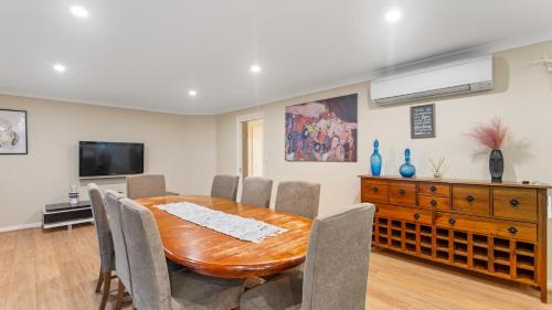 a dining room with a wooden table and chairs at McDougall Hidaway in Magpie