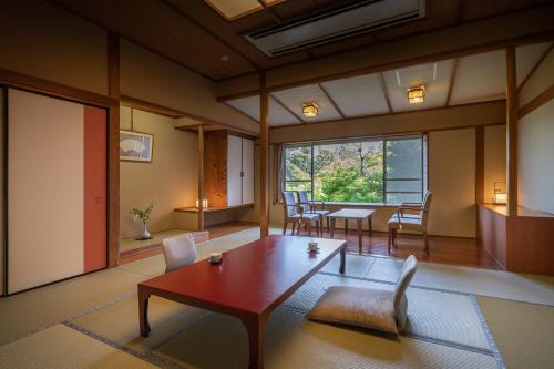 a living room with a wooden table and chairs at Fujiya in Niigata