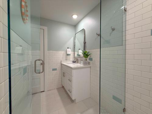 a white bathroom with a sink and a shower at B4 At Little Bay Landing in Rockport