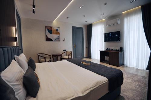 a hotel room with a large bed and a desk at RIO Hotel in Samarkand