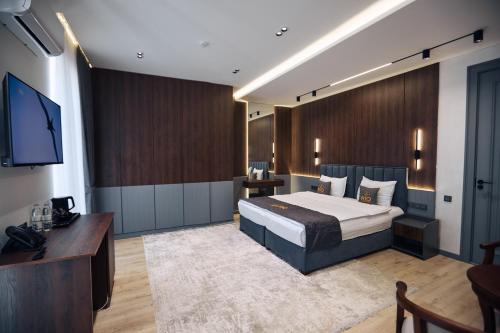 a bedroom with a bed and a flat screen tv at RIO Hotel in Samarkand