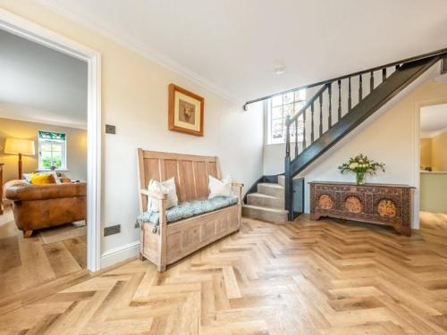 a living room with a staircase and a couch at Scarrow Beck House in Hanworth