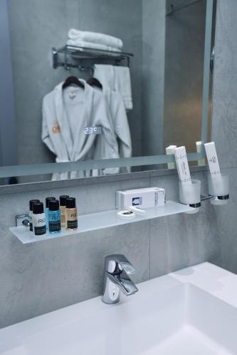 a bathroom with a sink and a mirror and a sink at RIO Hotel in Samarkand