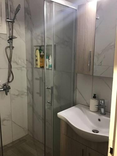 a bathroom with a shower and a sink at Dream house Peramos in Nea Peramos