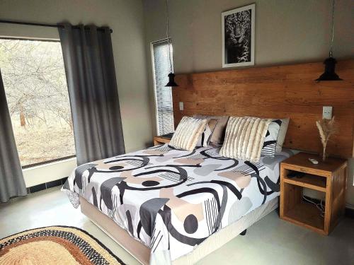 a bedroom with a large bed and a window at Switsongo B&B in Hoedspruit