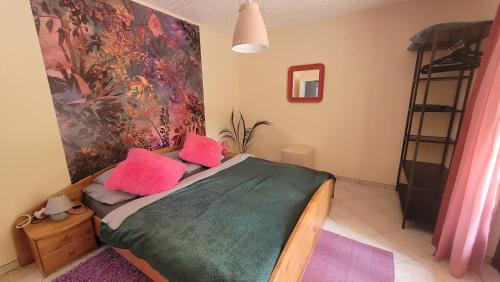 a bedroom with a bed with pink pillows on it at Villa Blu in Sankt Kanzian