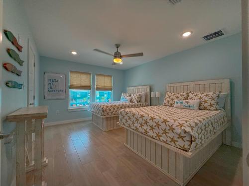 a bedroom with two beds and a ceiling fan at B5 Little Bay Landing Long Term in Rockport