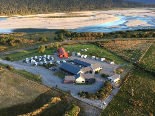 an aerial view of a parking lot next to a beach at Haast River Motels & Holiday Park in Haast