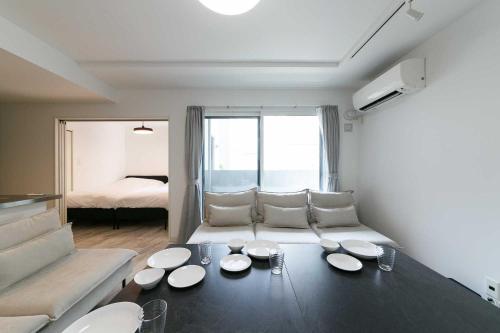 a living room with a table with plates on it at GaiarS8 in Sapporo