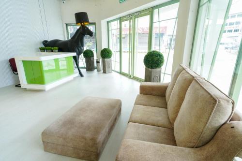 a living room with a chair and a horse statue at Robin Hotel in Ipoh
