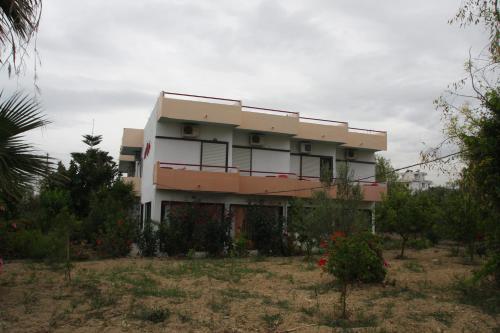 a building in the middle of a field at Violetta Hotel in Amoudara Herakliou