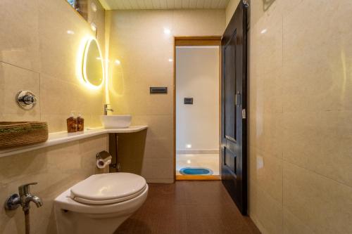 a bathroom with a toilet and a sink and a shower at Mysa by De Soul Santé in Morjim