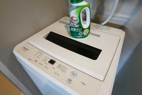 a bottle of soda sitting on top of a microwave at Twinberry CHITOSE in Chitose