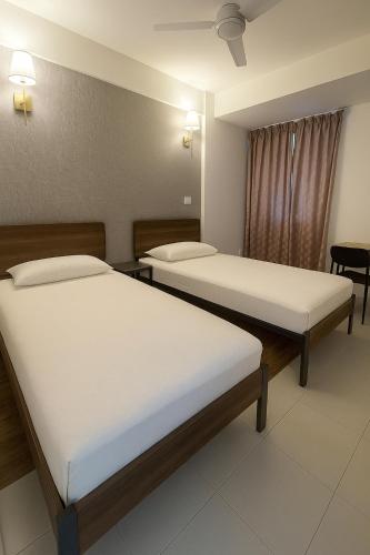 a room with two beds in a hospital at Arrival View in Male City