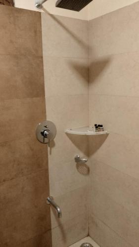 a bathroom with a shower with a toilet and a sink at Hotel Aroma Nainital In house parking in Nainital