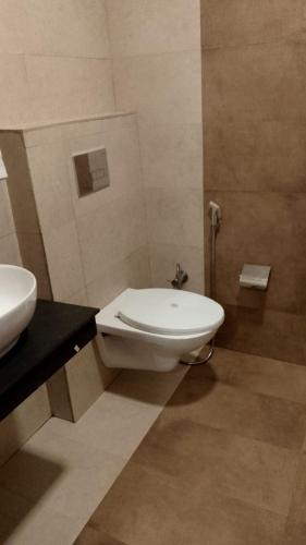 a bathroom with a toilet and a sink at Hotel Aroma Nainital In house parking in Nainital