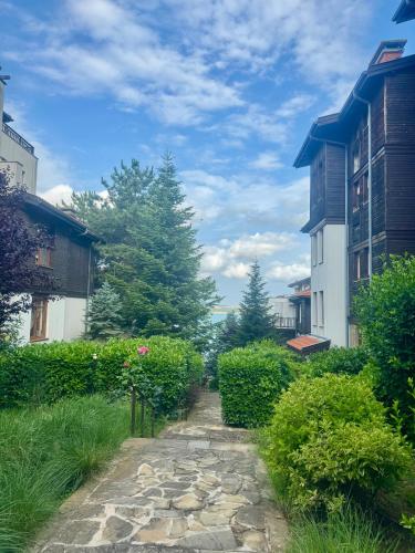 a stone path through a yard with buildings at Marena Studio - Santa Marina, Sozopol in Sozopol
