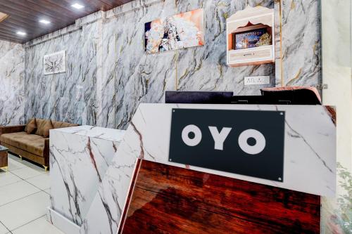 a table with an ovo sign on a wall at Hotel O Mannat in Indore