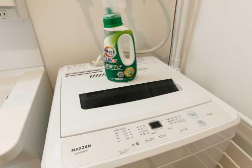 a bottle of laundry detergent sitting on top of a washing machine at EFFECT minami7 in Sapporo