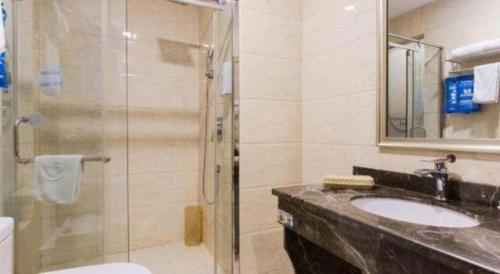a bathroom with a shower and a sink and a toilet at GreenTree Inn Hefei Huangshan Road Daxidi 1912 Express Hotel in Hefei