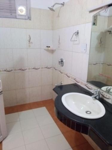 a bathroom with a sink and a mirror at Hotel Aroma Nainital In house parking in Nainital