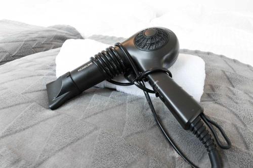 a blow dryer is sitting on a bed at EFFECT minami7 in Sapporo