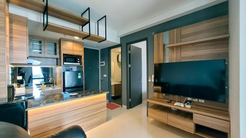 a living room with a large flat screen tv at Palam Mansion at Apartment One Residence in Batam Center