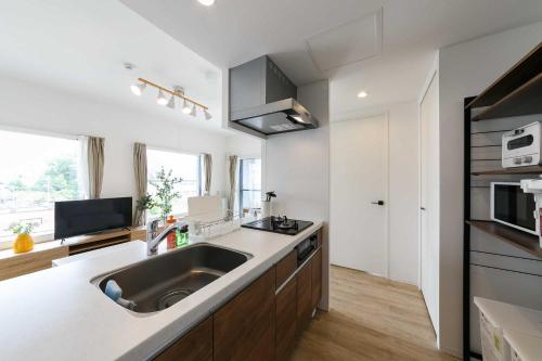 a kitchen with a sink and a counter top at EFFECT minami7 in Sapporo