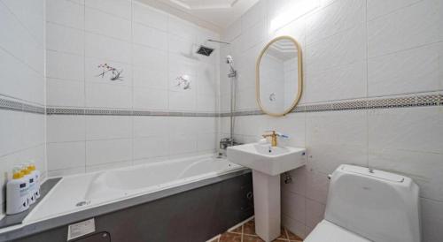a bathroom with a sink and a tub and a toilet at Luxury Motel Daejeon in Daejeon