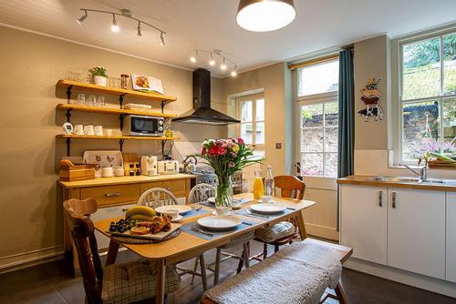 a kitchen with a table and chairs and a dining room at Cosy cottage in the heart of Bakewell in Bakewell