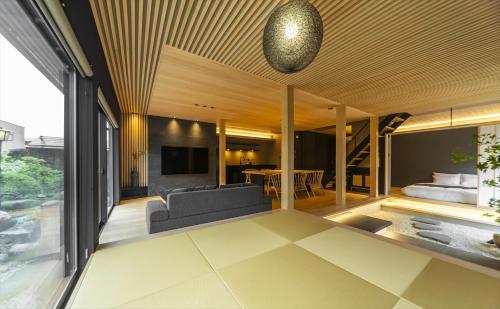 an open living room with a couch and a table at GLOWVIA Takayama-showa in Takayama