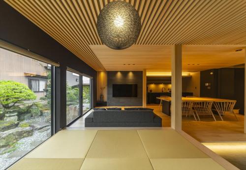 a living room with a couch and a television at GLOWVIA Takayama-showa in Takayama