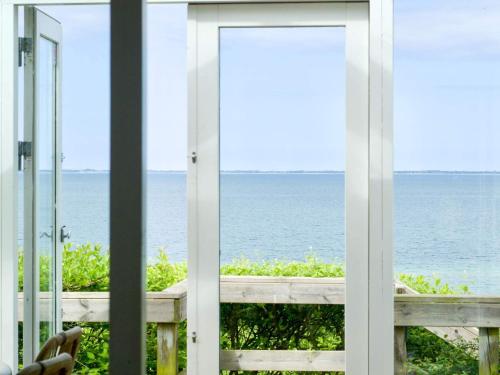 a window view of the ocean from a house at 4 star holiday home in Asnæs in Asnæs