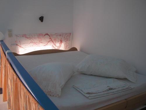 a bed in a room with a bed frame at Popi Studios in Astypalaia