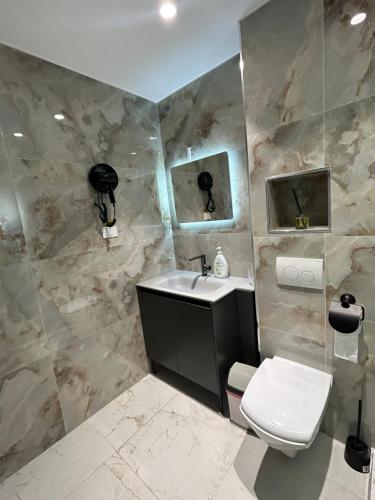 a bathroom with a sink and a toilet at miami costinesti in Costinesti