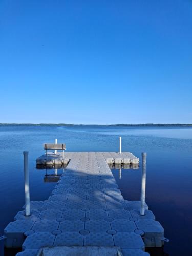 a dock in the middle of a body of water at Villa Lakeside in Osbyholm