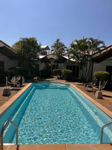 a swimming pool with blue water in a resort at Vivi Bungalows Resort in Nai Harn Beach