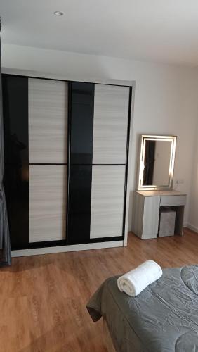 a bedroom with a dresser and a bed and a mirror at Quill Residence- Minimalist Urban Condo by Azmila in Kuala Lumpur