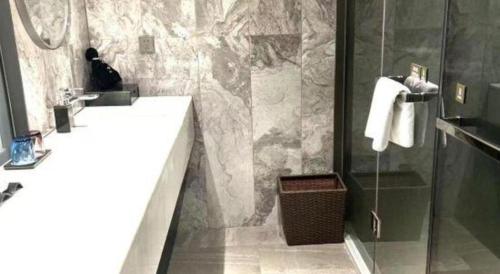 a bathroom with a sink and a shower at Taiyi International Hotel in Wenzhou