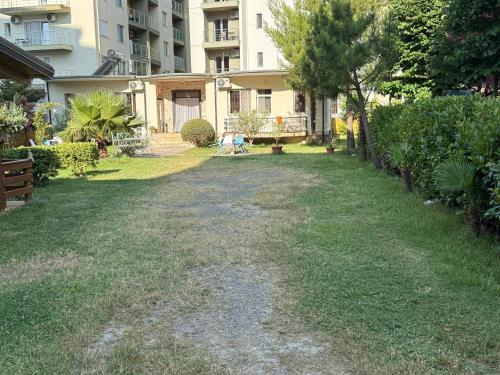 an empty yard with a building in the background at Guroal Holiday House in Shëngjin