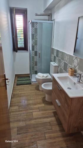 a bathroom with a toilet and a sink at A casa di Ale in Mascali