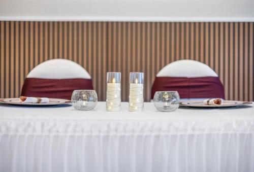 a table with plates of food and glasses on it at Prodigy Hotel, a Days Inn by Wyndham in Davis